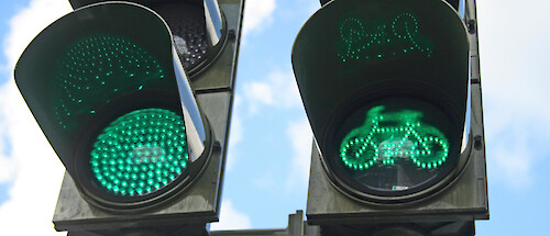 A green traffic light, also displaying a green bicycle light