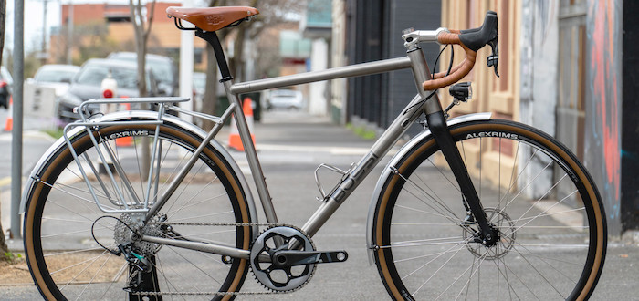 Custom-build Bossi Grit titanium bicycle, shot on a city footpath
